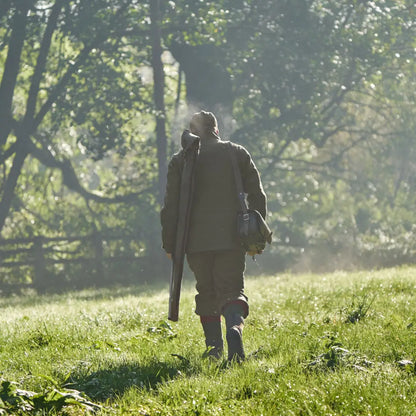 Hunter walking with rifle wearing Harkila Kenmore GTX Breeks outdoor gear