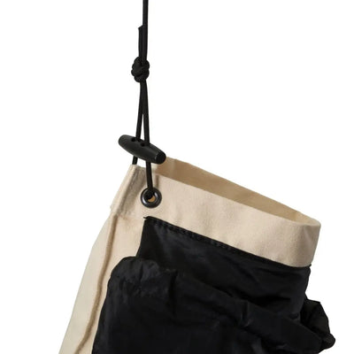 Hanging fabric storage organizer with black and beige compartments for a water filter bag