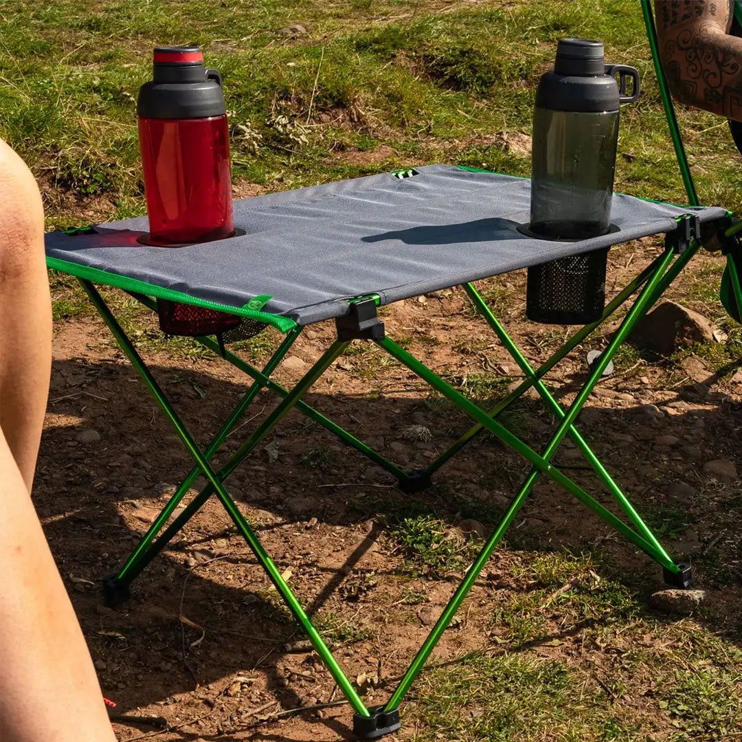 Portable Highlander Ayr Folding Camping Table with green legs and gray top for outdoors