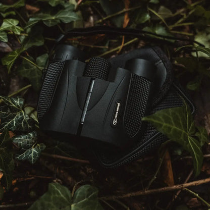Highlander Tarn 8X21 Binoculars nestled in foliage, offering outstanding vision in nature