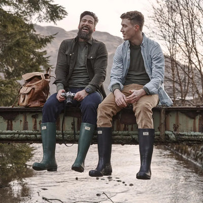 Two guys chilling on a railing in Hoggs Of Fife Braemar Wellington Boots