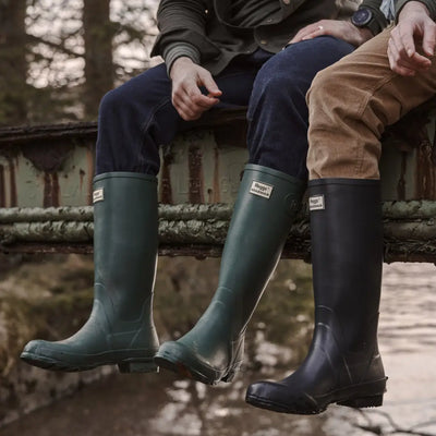 Hunter green and black Hoggs Of Fife Braemar Wellington Boots on two friends’ feet