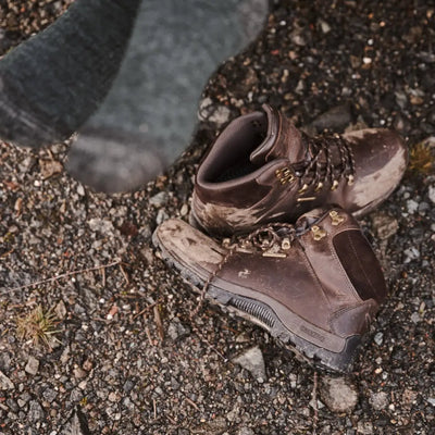 Worn brown hiking boots on rocky ground showcasing Fife Glencoe Waterproof Trek design