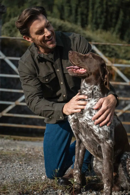 Brown leather jacket with black buttons and pockets worn with blue jeans, Fife Moy Moleskin style