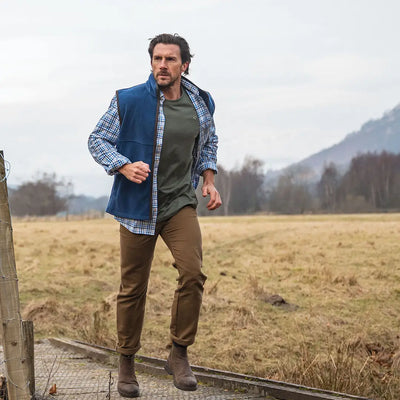 Man in outdoor clothing wearing a Hoggs of Fife Stenton Technical Fleece Gilet
