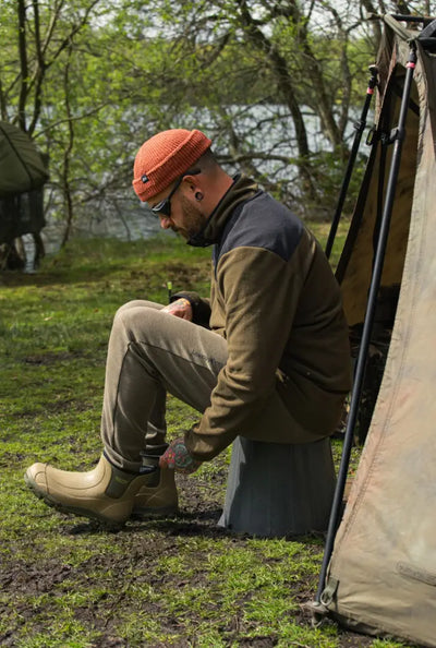Man showcasing Jack Pyke Ankle Wellie Boots in stylish tan color