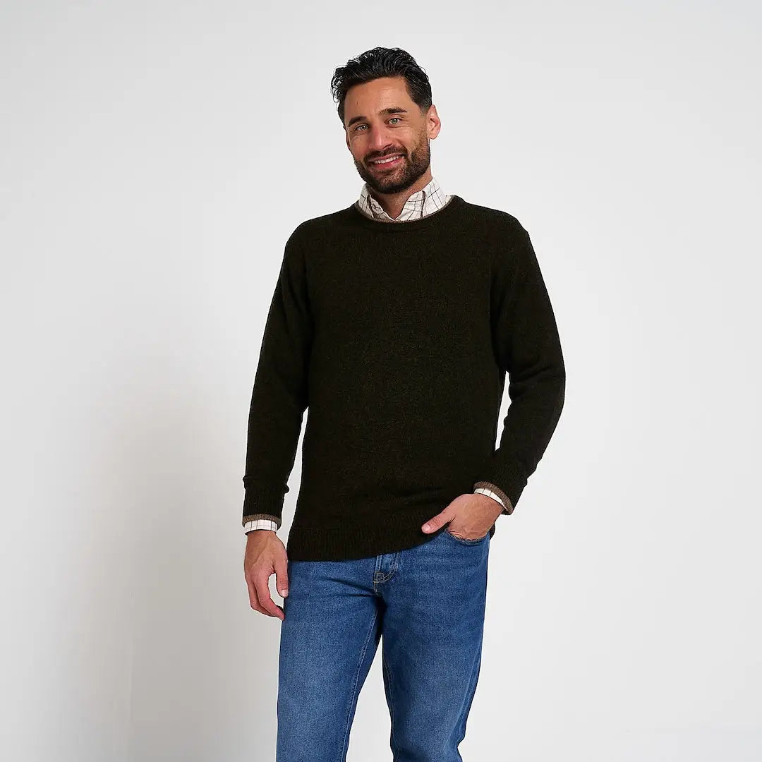 Jack Pyke Ashcombe dark green lambswool crewneck pullover layered over plaid shirt