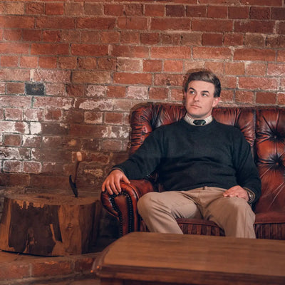 Man in leather armchair wearing Jack Pyke Ashcombe 100% Lambswool Crewknit Pullover