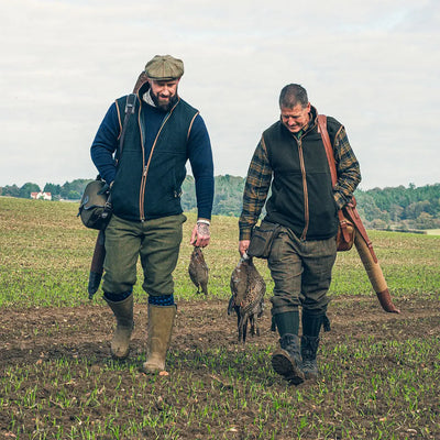 Two hunters with game birds wearing Jack Pyke Countryman 300gsm Micro Fleece Gilet