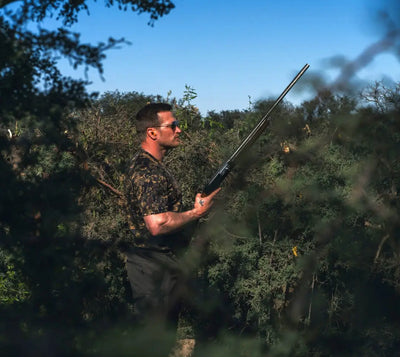 Man holding a shotgun wearing a Jack Pyke Digital Camo T-Shirt outdoors