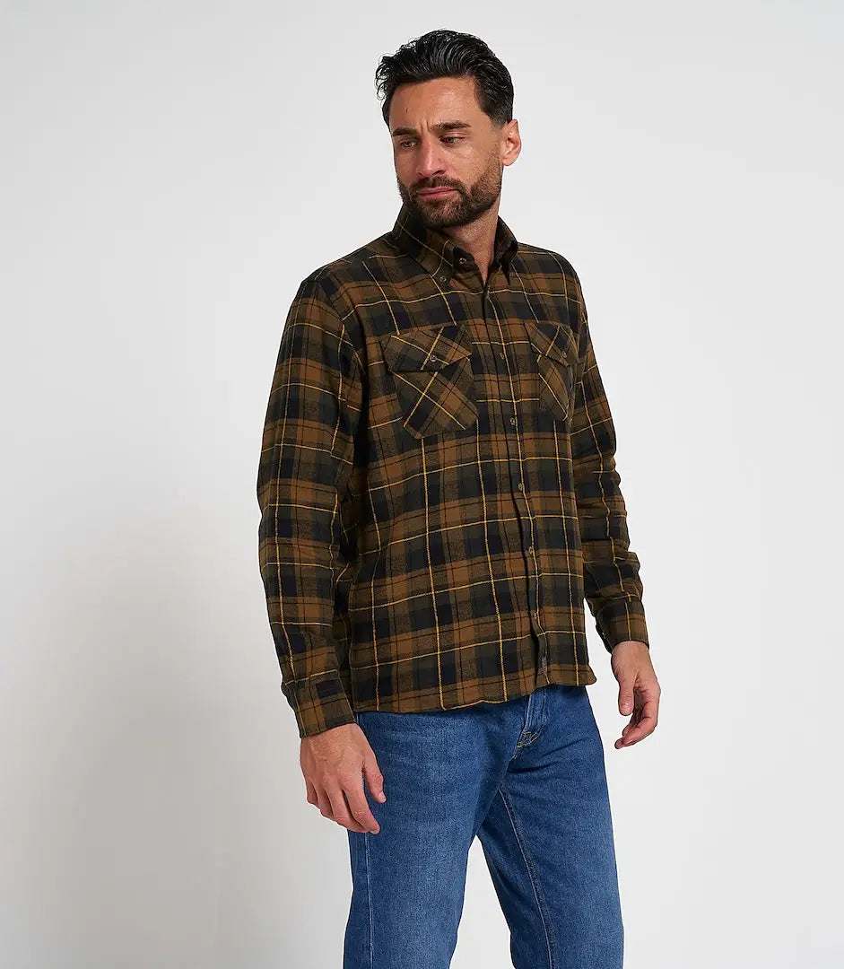 Man in Jack Pyke flannel shirt with brown black plaid and chest pockets