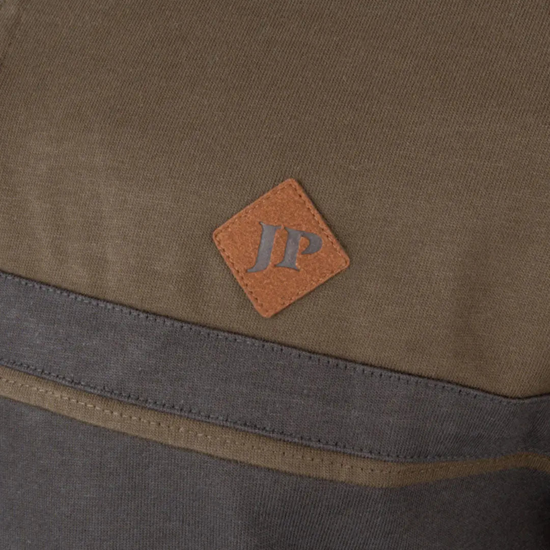 Jack Pyke half zip contrast sweatshirt with brown leather JP patch on olive green canvas backpack