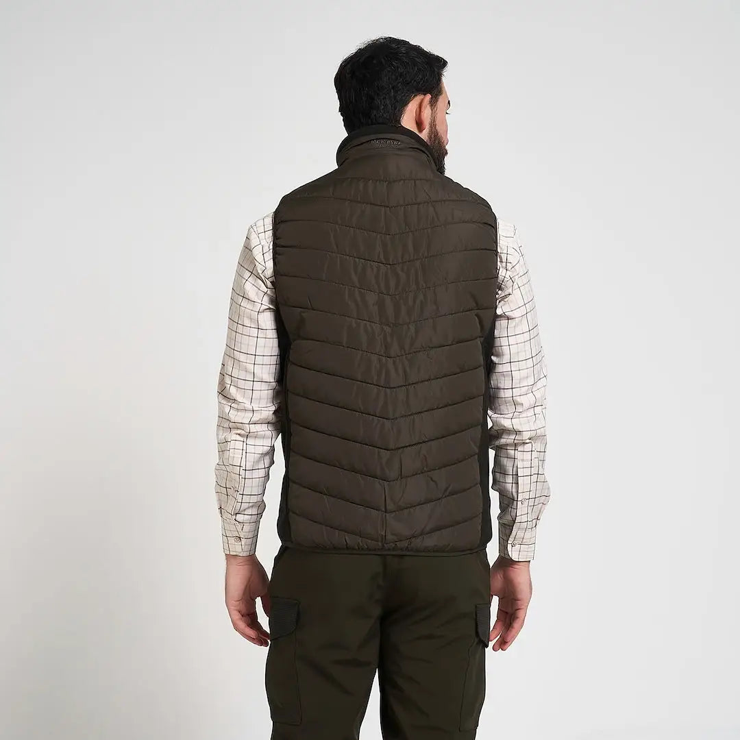 Jack Pyke Hybrid Quilted Gilet in dark olive over plaid shirt