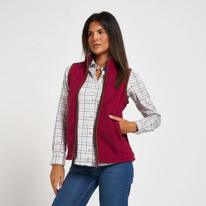 Jack Pyke Ladies Countryman Gilet: maroon fleece vest with brown zipper over plaid shirt