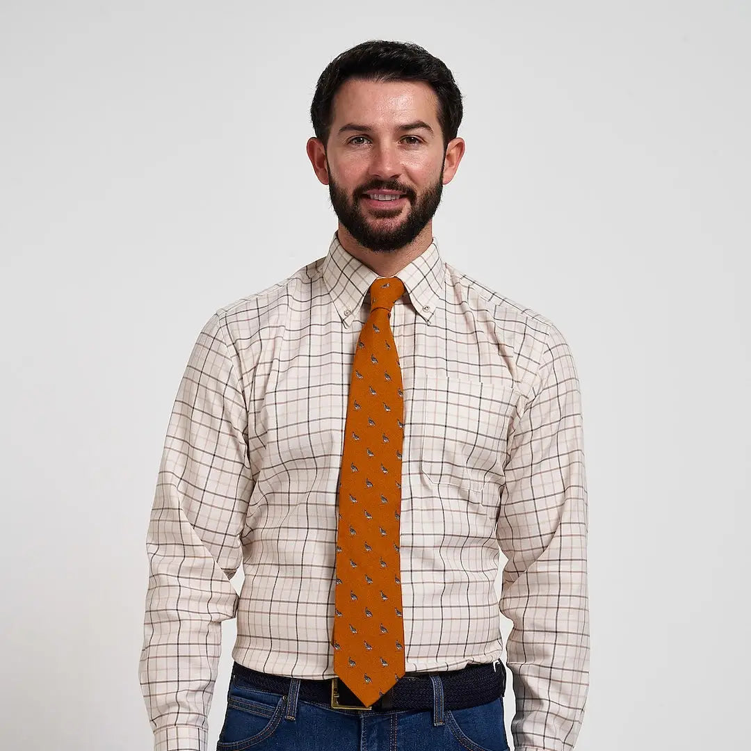 Vibrant Jack Pyke Partridge silk tie in orange with subtle dark motifs