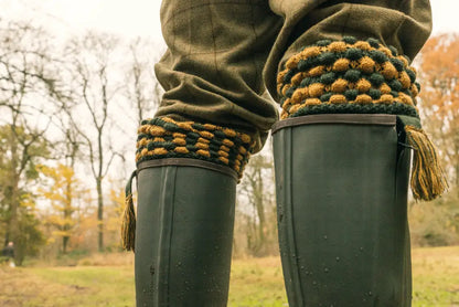Green rubber boots with cozy knitted cuffs next to Jack Pyke Pebble Shooting Socks