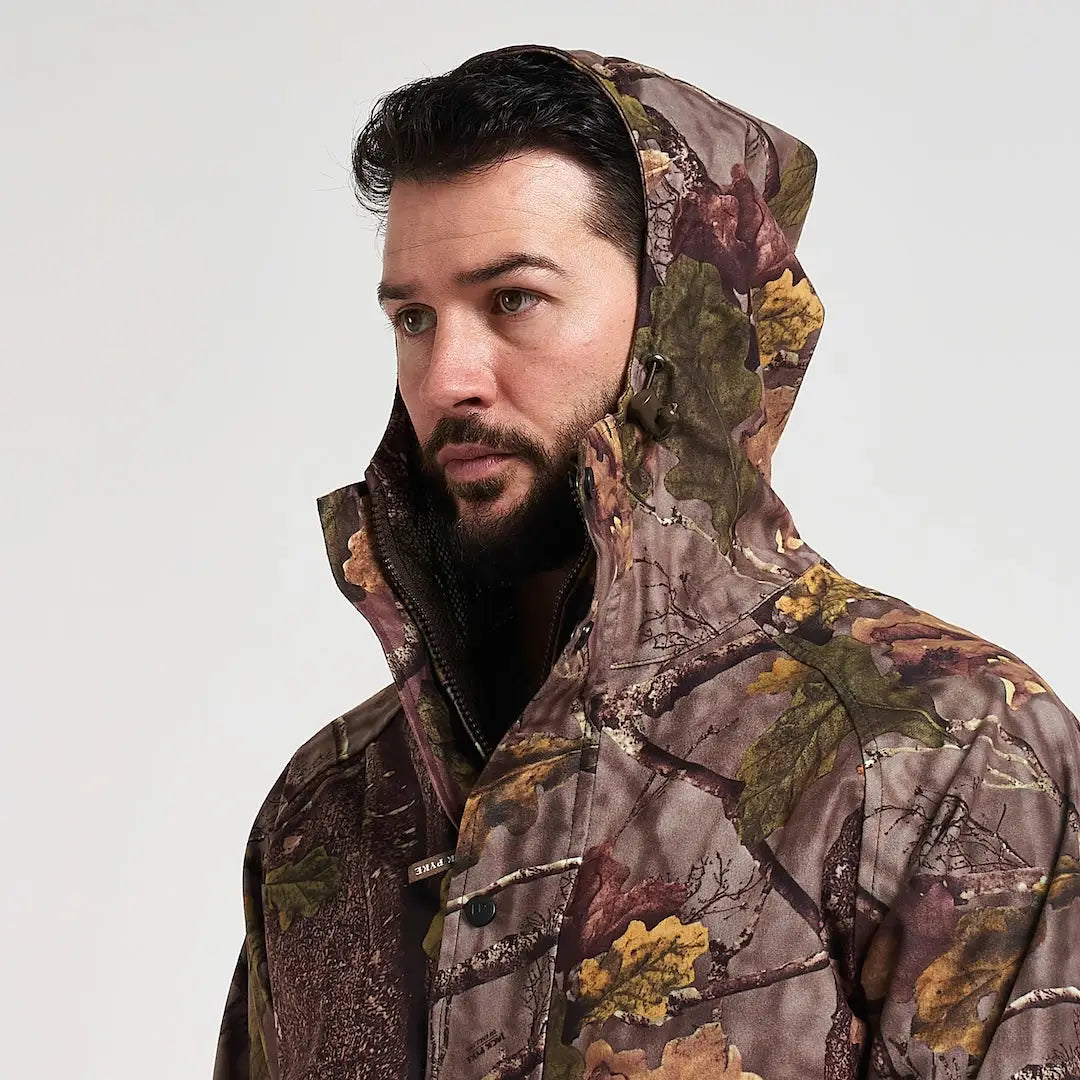 Man in Jack Pyke Rannock waterproof hunting jacket with camo pattern