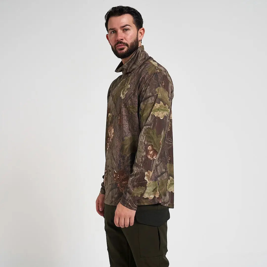 Man in Jack Pyke roll neck top with camo leaves for fieldsports activity