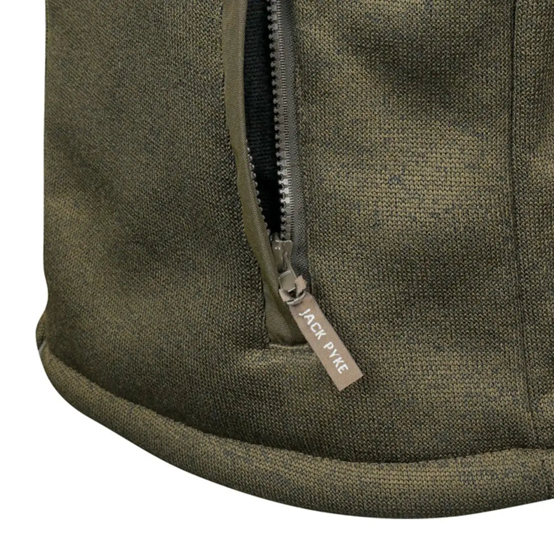 Olive green waxed canvas backpack with Jack Pyke branding in Scandinavian fleece jacket