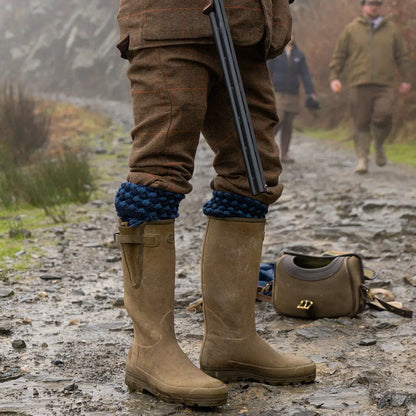 Tan rubber hunting boots with blue leg warmers in Jack Pyke country clothing