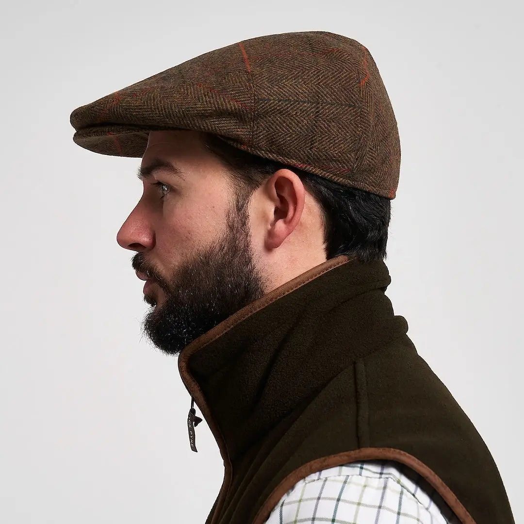 Jack Pyke wool blend flat cap in brown herringbone tweed with red beige plaid accents