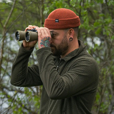 Man using binoculars while wearing a comfortable Jack Pyke Z Fleece Pullover