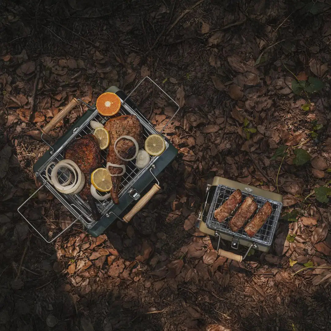 Portable Kenluck Buddy Grill with delicious food ready for your next BBQ adventure