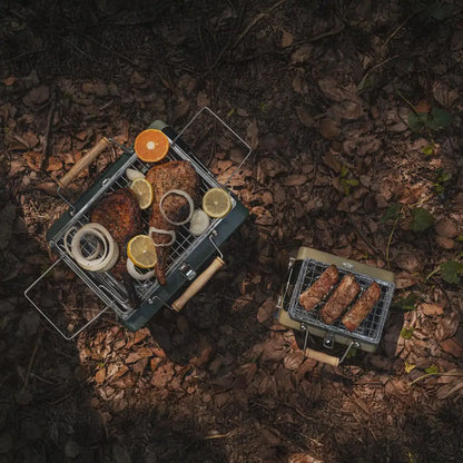 Portable Kenluck Buddy Grill with delicious food ready for your next BBQ adventure
