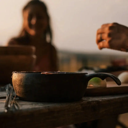 Rustic cast iron pot in Kupilka Bowl, perfect for outdoor meals with natural fibre composite