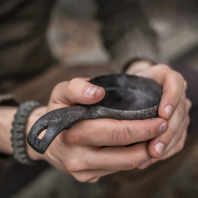 Hand-held dark metal Kupilka Classic Cup perfect for country clothing, hunting, and outdoors