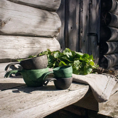 Stacked rustic Kupilka Large Cup mugs with birch leaves, perfect for country clothing and outdoors