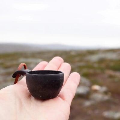 Small dark wooden Kupilka Mini Cup with handle, perfect for outdoor adventures