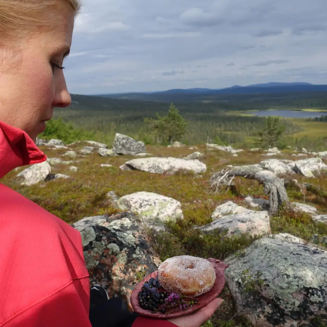 Sugar-coated donut with berries on a Kupilka Small Plate, perfect for outdoor adventures