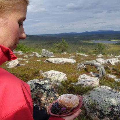Sugar-coated donut with berries on a Kupilka Small Plate, perfect for outdoor adventures