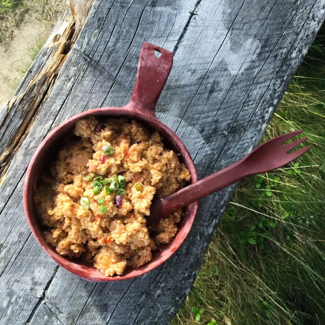 Brown couscous in a Kupilka Spork bowl, perfect for outdoor country clothing adventures