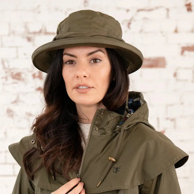 Woman in an olive green Lighthouse Canterbury Waterproof Ladies Hat and jacket
