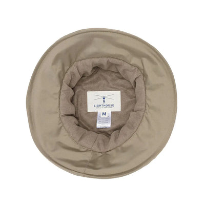 Beige khaki bucket hat with label, perfect for the Lighthouse Canterbury Waterproof Ladies Hat