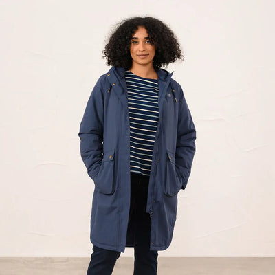 Woman wearing Lighthouse Imogen Ladies Coat in navy blue with striped shirt and dark pants