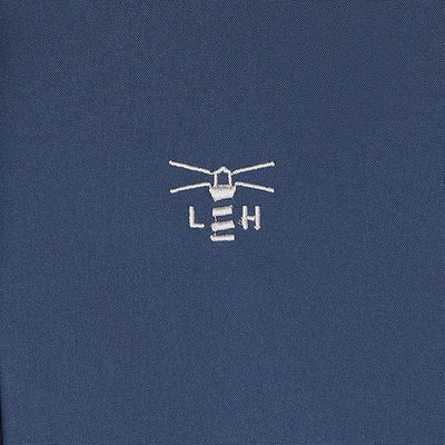 Embroidered lighthouse logo on dark blue Lighthouse Imogen Ladies Coat fabric
