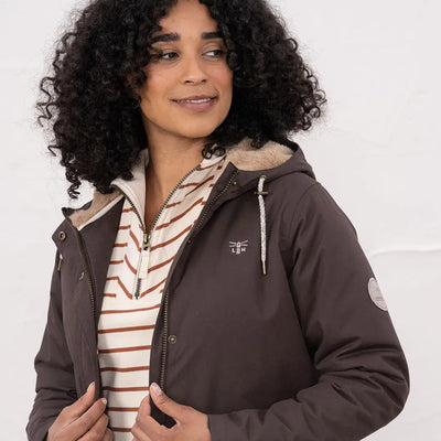 Woman wearing Lighthouse Isobel Coat with hood, faux fur lining, and striped shirt