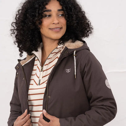 Woman wearing Lighthouse Isobel Coat with hood, faux fur lining, and striped shirt