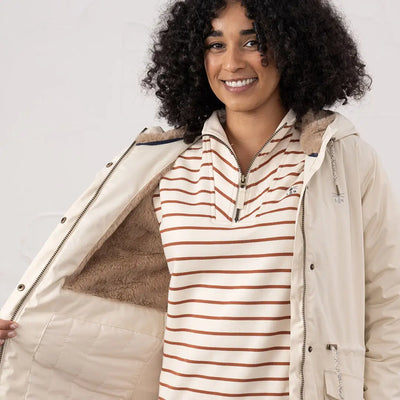 Woman wearing Lighthouse Isobel Coat with fur-lined parka and striped shirt outdoors