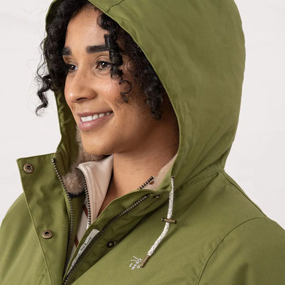 Woman in olive green Lighthouse Isobel Coat with fur-lined collar in outdoor setting