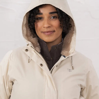 Woman wearing lighthouse Isobel coat cream hooded parka with dark brown lining