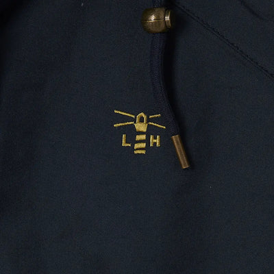 Embroidered LEH logo with whiskers on dark fabric from Lighthouse Heritage Collection