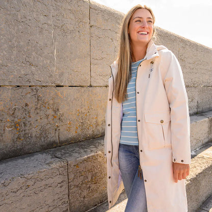 Lighthouse Ladies Annika Coat showcasing a long light-colored raincoat for women