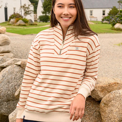 Woman wearing Lighthouse Ladies Coral Jersey quarter-zip sweatshirt in cream and brown stripes