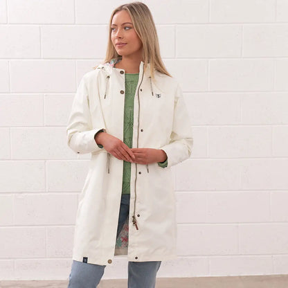 Woman wearing white Lighthouse Ladies Pippa Coat, stylish ladies Pippa coat for rainy days