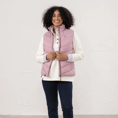 Lighthouse Laurel ladies pink quilted vest with cream top and dark blue trousers