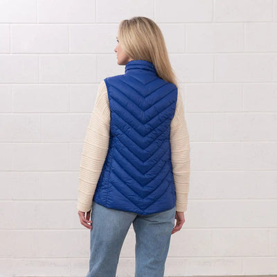 Woman in a blue puffer vest from the Lighthouse Laurel collection, perfect for country clothing